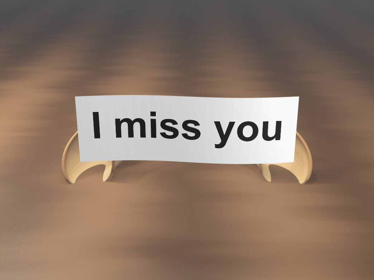 I miss you GIF: a fortune cookie cracked open on a table, with a paper slip reading I miss you