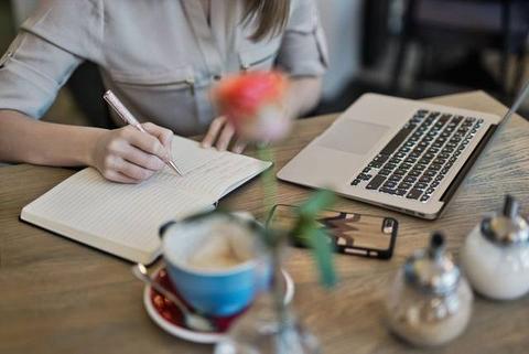 Person working on a creative project on a laptop